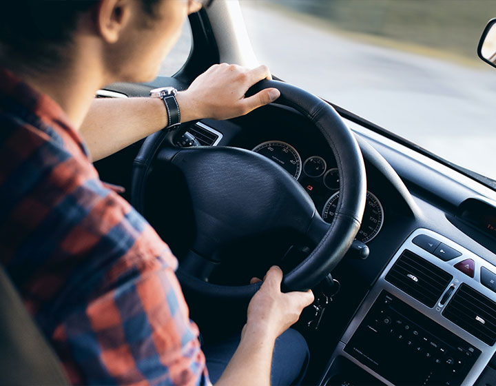 Man with his hands on the wheel with Car Insurance in Shawnee, OK