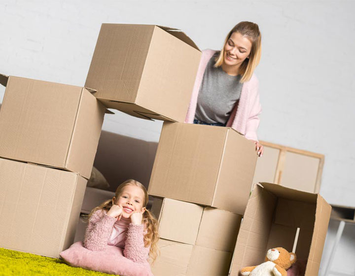 Family Moving boxes into new home with Home Insurance in Moore, OK