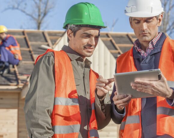 Construction Crew Looking at iPad with Contractors Insurance in Oklahoma City